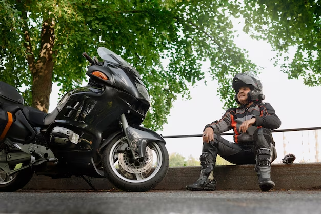 Man sitting near a motorcycle