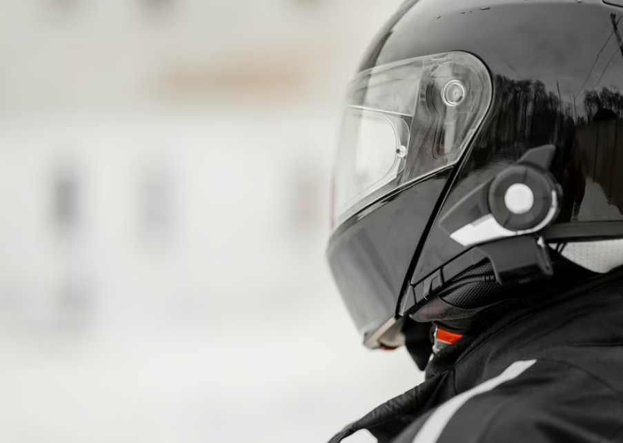 person in black jacket and helmet, and blurred white background