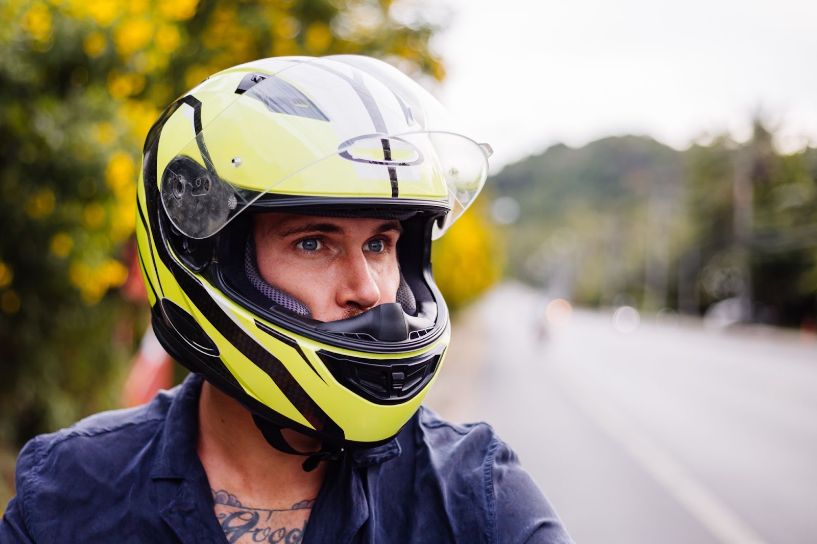 Male biker in yellow helmet