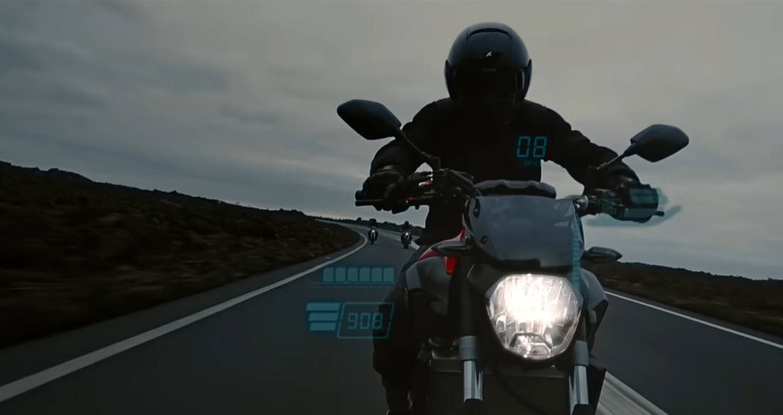 A rider on a motorcycle with a futuristic heads-up display