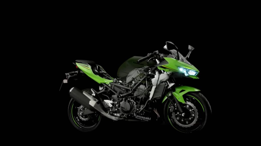 An exposed Kawasaki Ninja 400 showing its frame and engine on a dark background