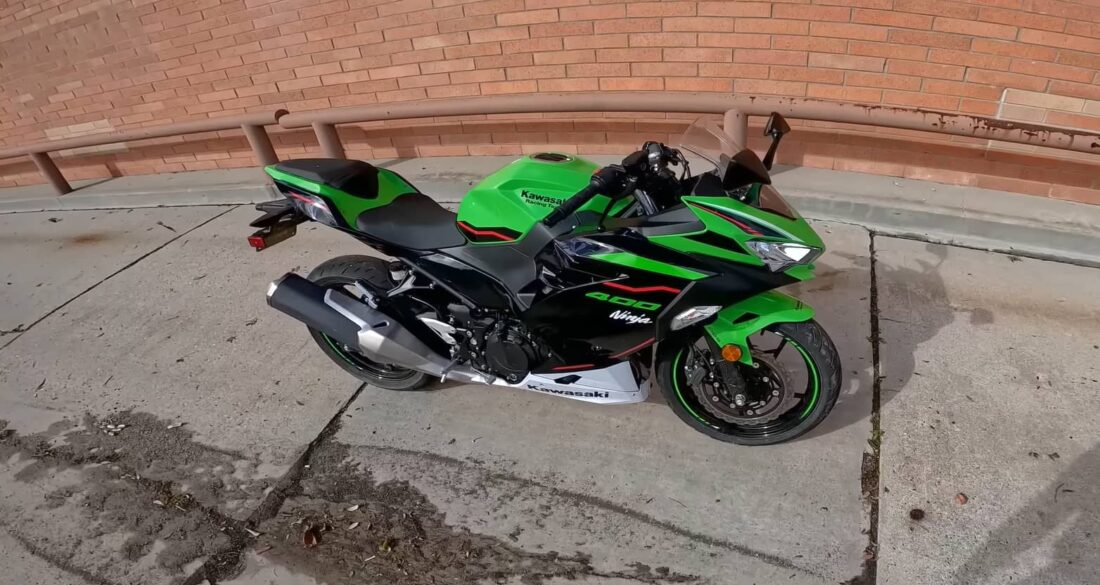 A Kawasaki Ninja 400 motorcycle parked outside on a sunny day