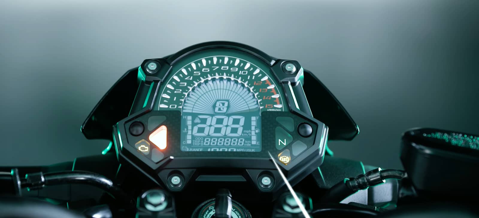 Motorcycle dashboard illuminated with a digital speedometer and various indicators