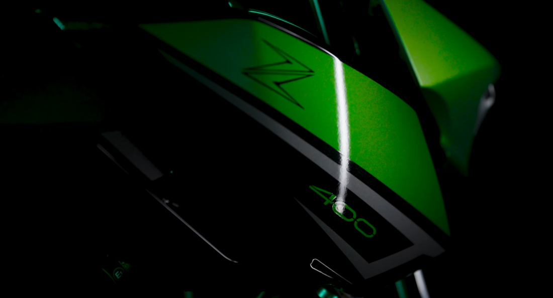 Close-up of a green motorcycle with sleek black accents and the number 400